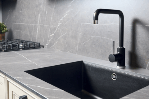 Design essentials for porcelain countertops shown in a contemporary kitchen with a black under-mount sink.