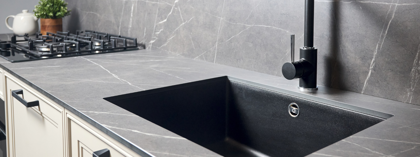 Design essentials for porcelain countertops shown in a contemporary kitchen with a black under-mount sink.