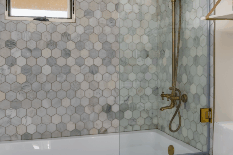 Contemporary bathroom design highlighting glass tile mosaic shower walls.
