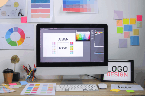 Creative design workspace with color wheels and branding software for kitchen and bath brand strategy.