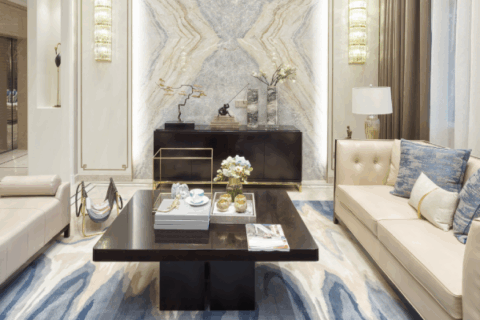 Luxury lounge space featuring a marble accent wall and sleek leather seating.