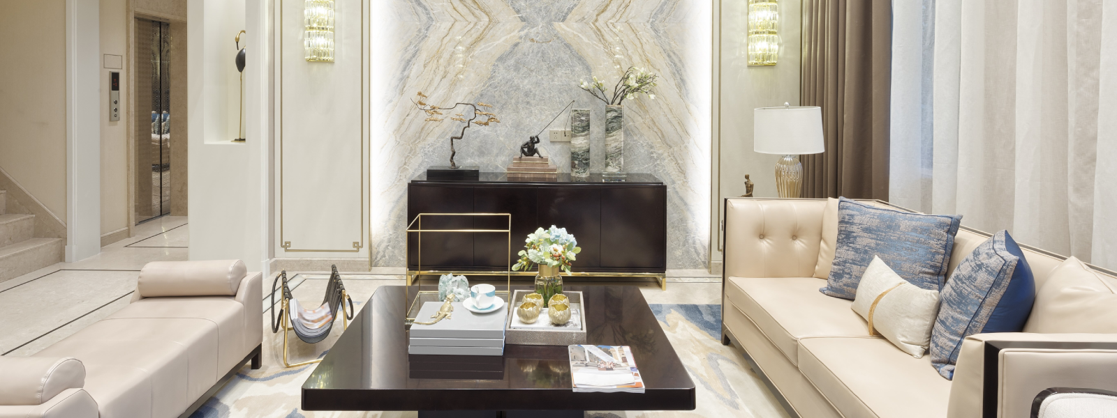 Luxury lounge space featuring a marble accent wall and sleek leather seating.