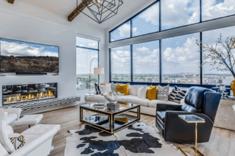 Camera-ready living room with floor-to-ceiling windows and dramatic lighting.