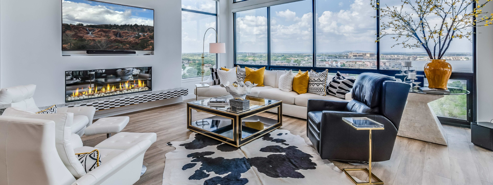 Camera-ready living room with floor-to-ceiling windows and dramatic lighting.