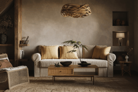 Thoughtfully styled living room with earth-toned decor, natural textures, and a woven pendant light.