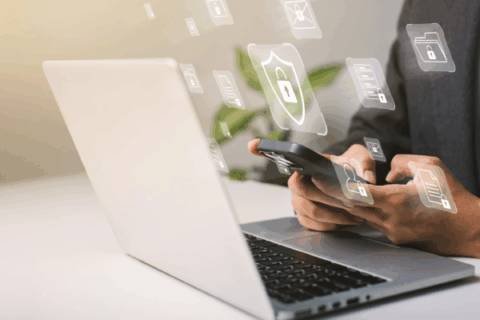 Interior designer managing secure digital client data and protecting creative work on a laptop and smartphone.