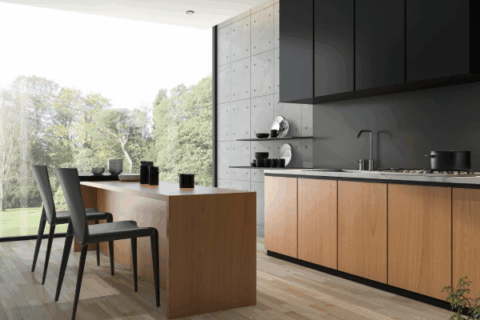 Minimalist clutter-free kitchen with warm wood cabinetry and clean counter space