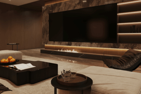 Luxury home theater with marble wall, flat screen, and ambient lighting