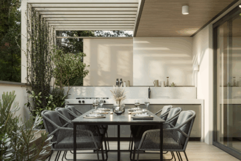 Covered modern patio with outdoor kitchen counter, dining table, and slatted pergola structure