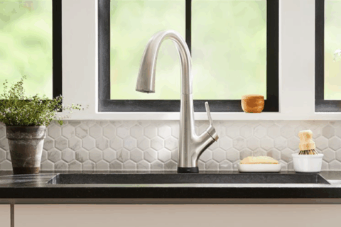 Brushed nickel kitchen faucet, undermount sink, and marble tile backsplash